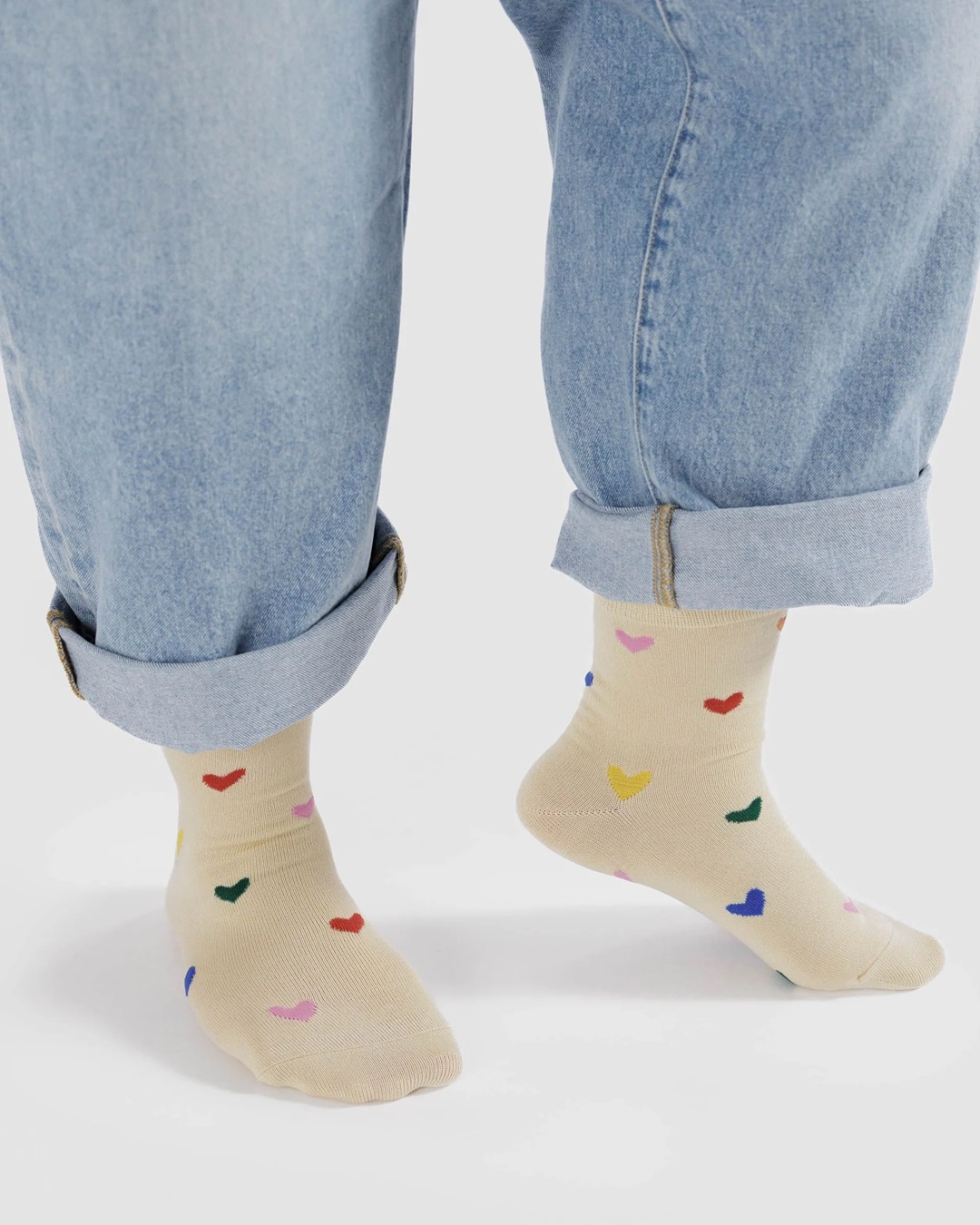 Cream socks with multi coloured hearts on feet