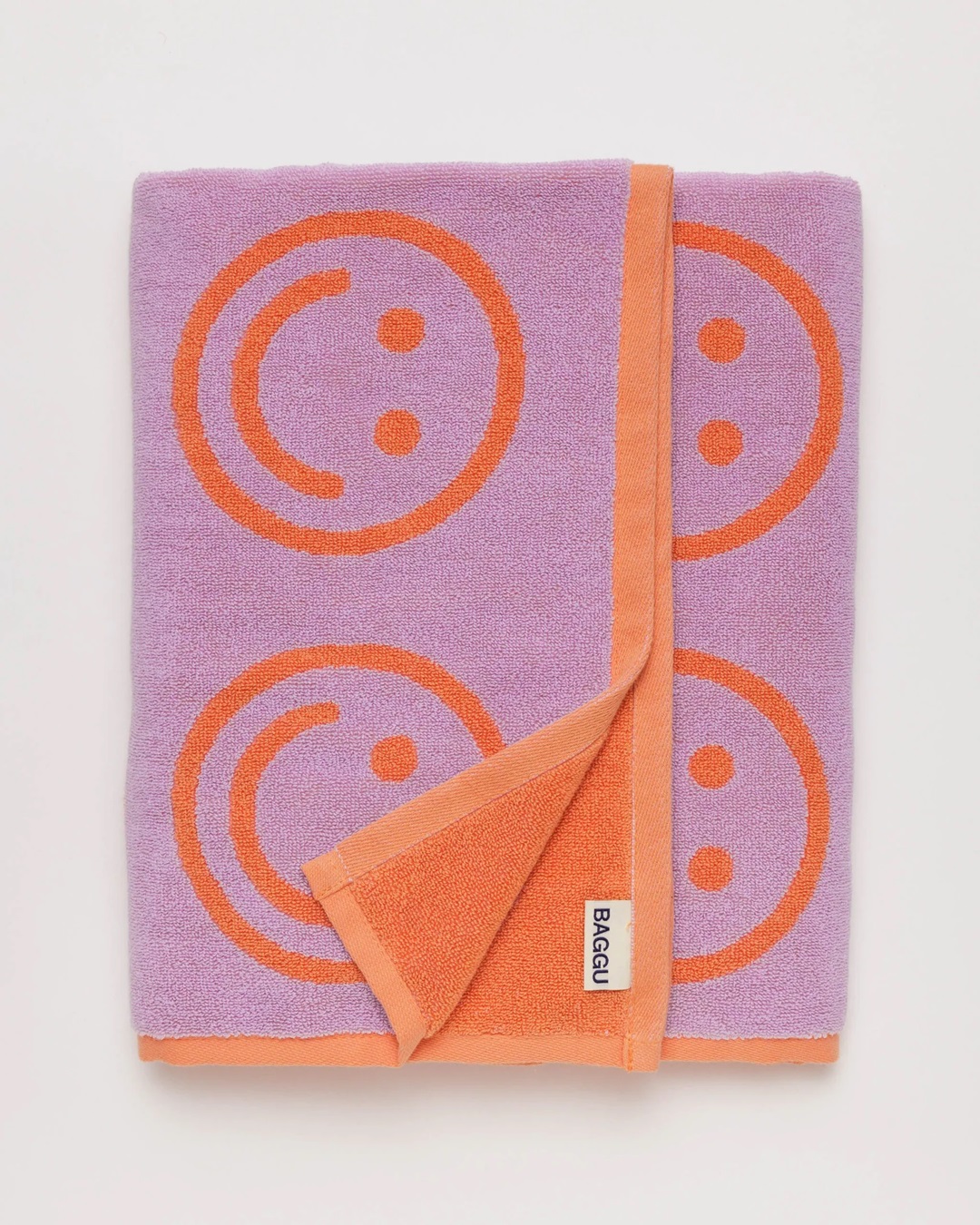Orange and purple smiley face towel folded