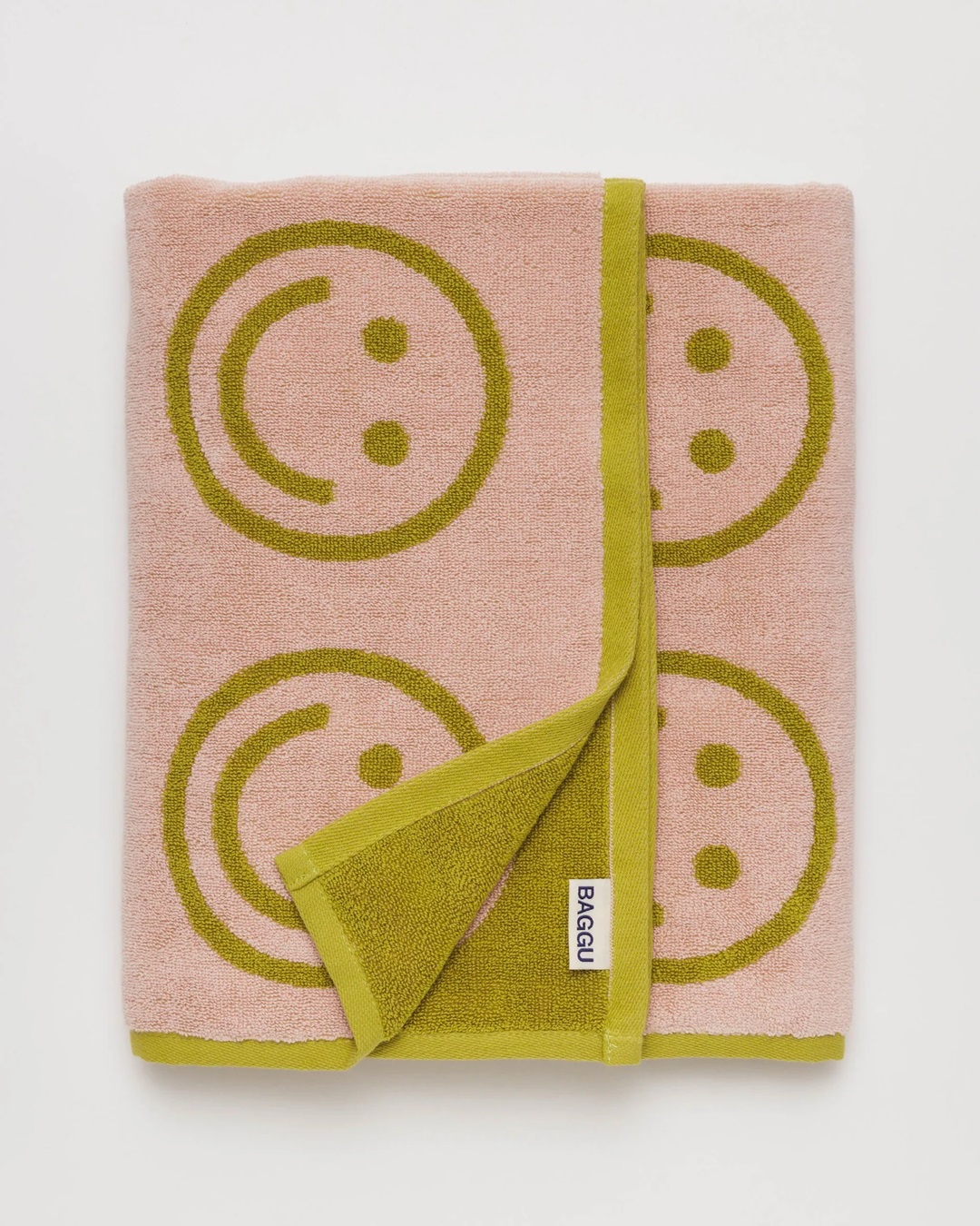 Green and pink smiley face towel