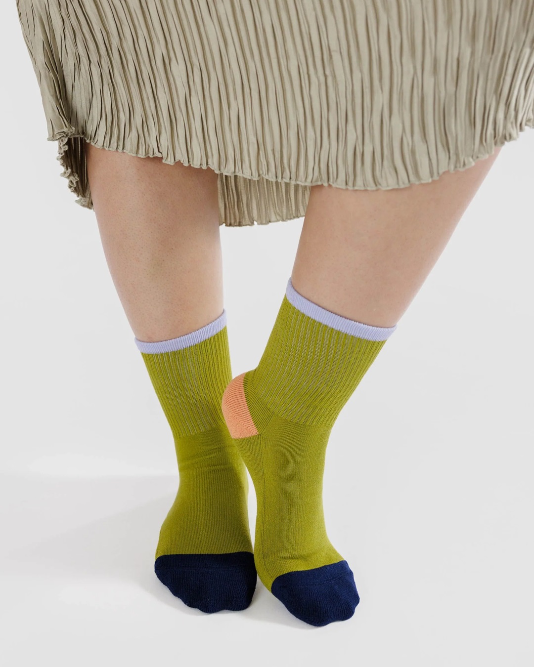 Lemongrass pair of socks of feet with navy blue coloured toes and orange heels