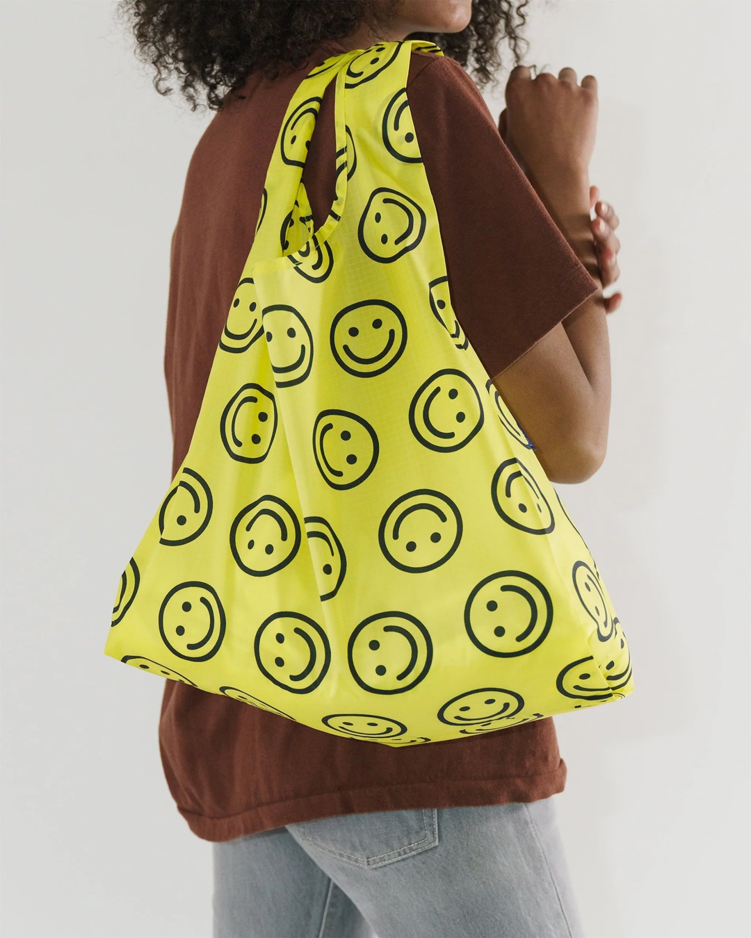 Yellow smiley face bag on shoulder