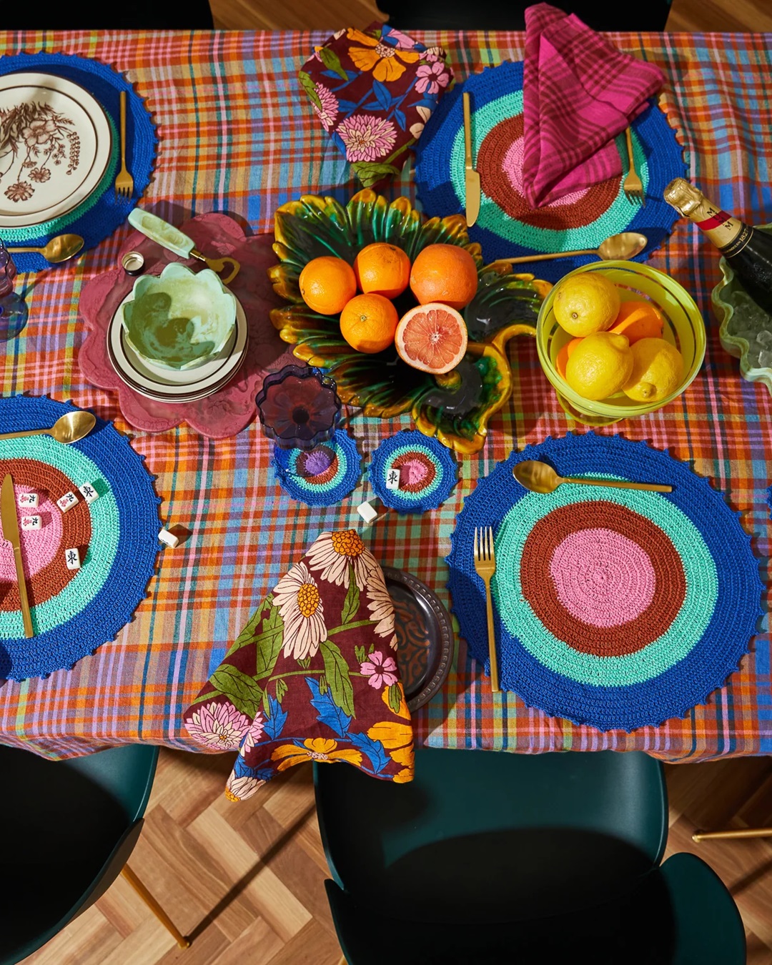 Colourful dining table with food, table cloth, napkins and fruit