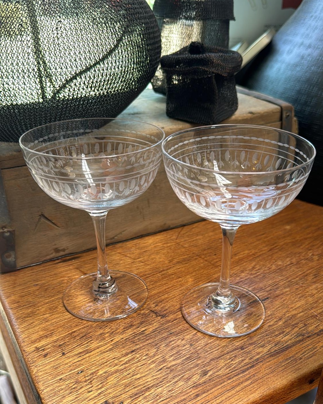 Two crystal champagne glasses on shelf