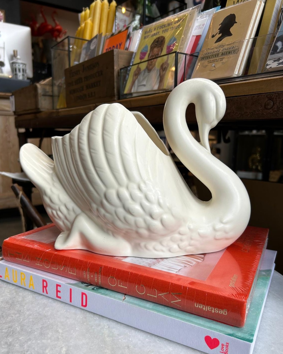White swan ceramic on books