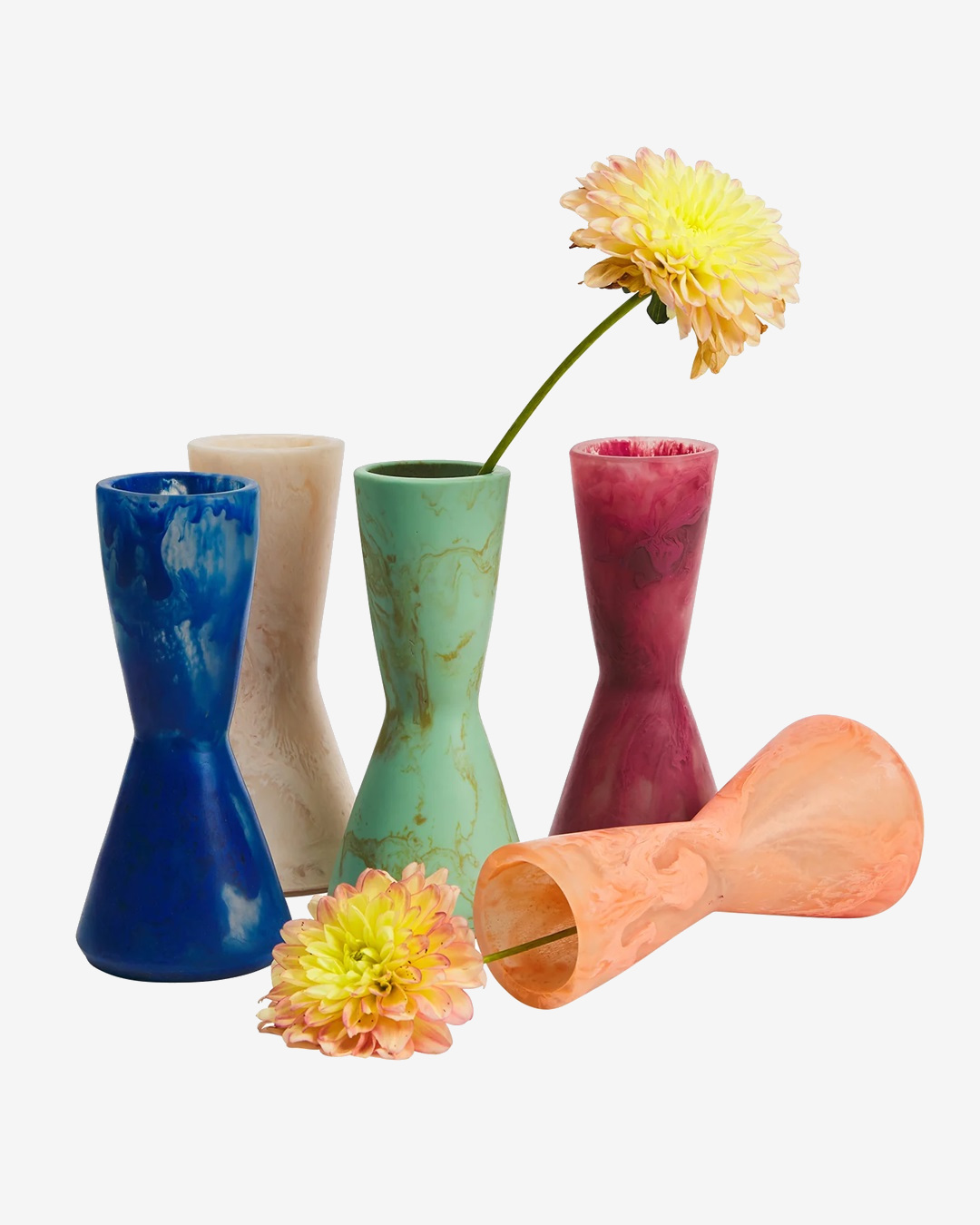 Different coloured resin vases with flowers