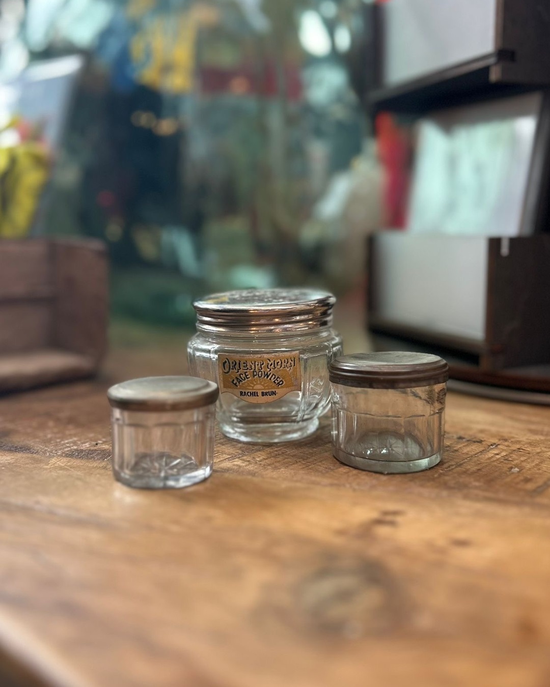 2 glass jars with silver lids on wooden table