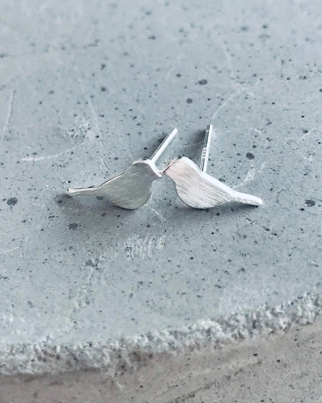 Little bird silver stud earrings on stone