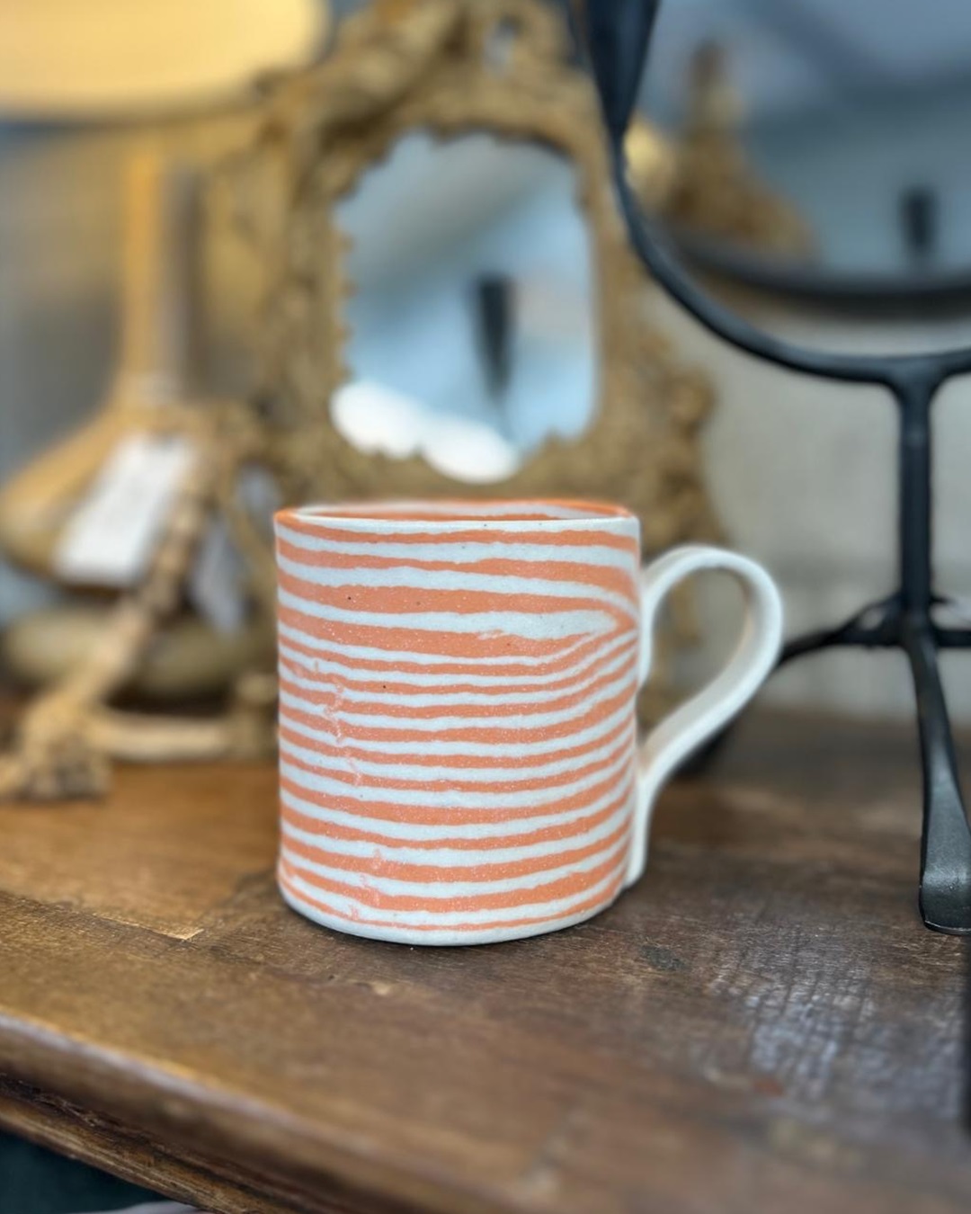 Orange stripe ceramic mug on shelf