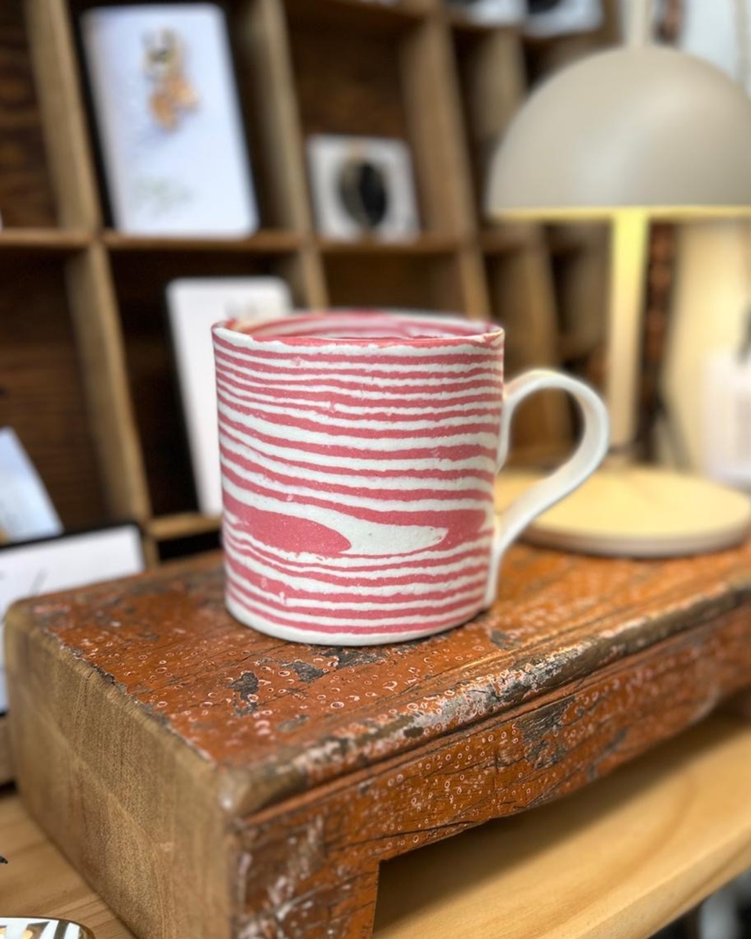 Pink stripe ceramic mug on shelf