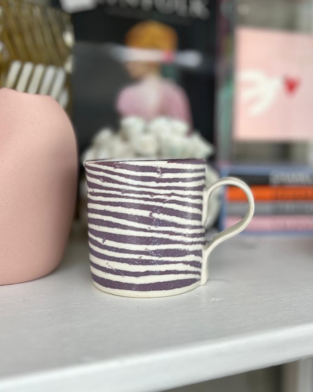 Purple stripe ceramic mug on shelf