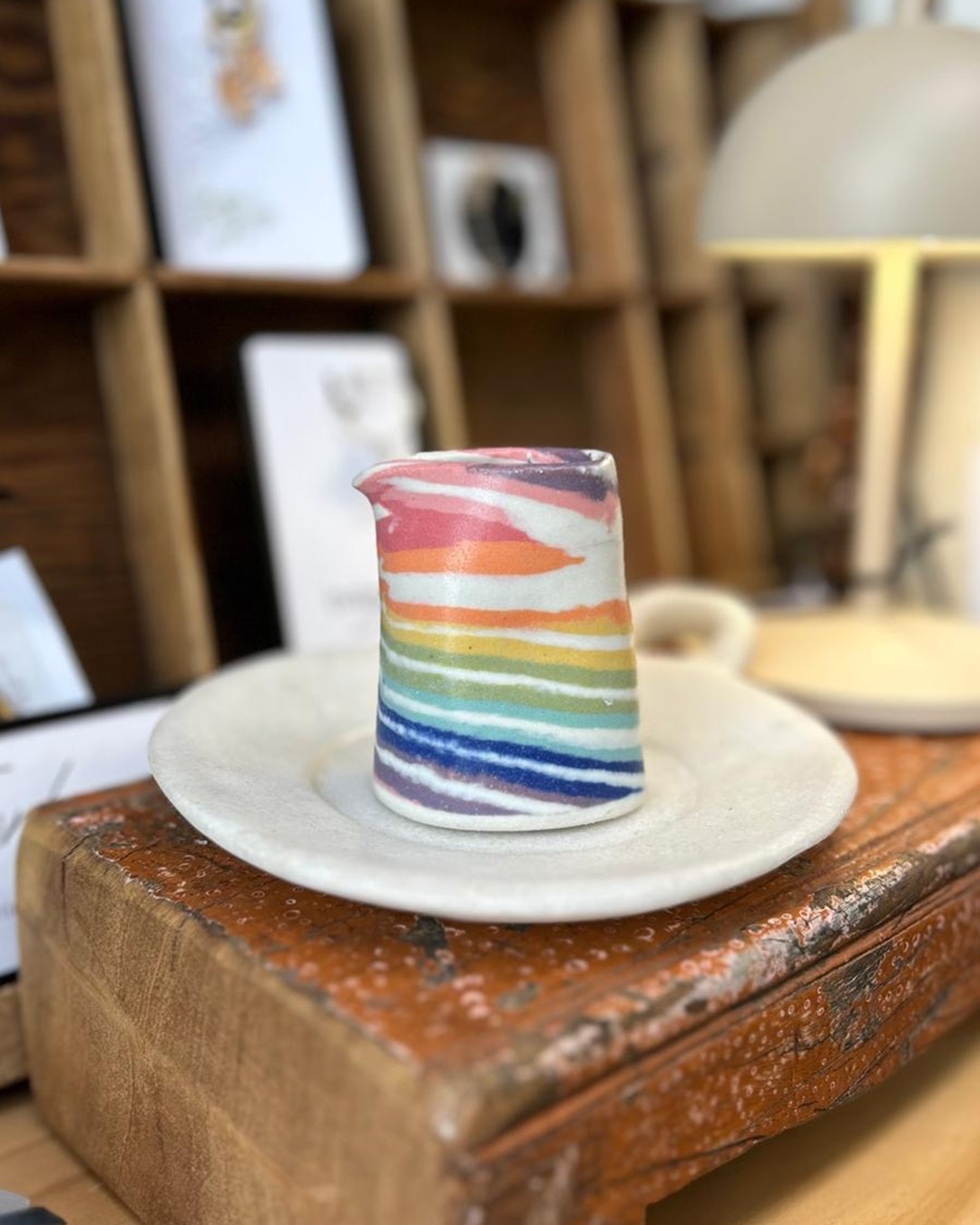 Rainbow Nerikomi ceramic jug on plate on shelf