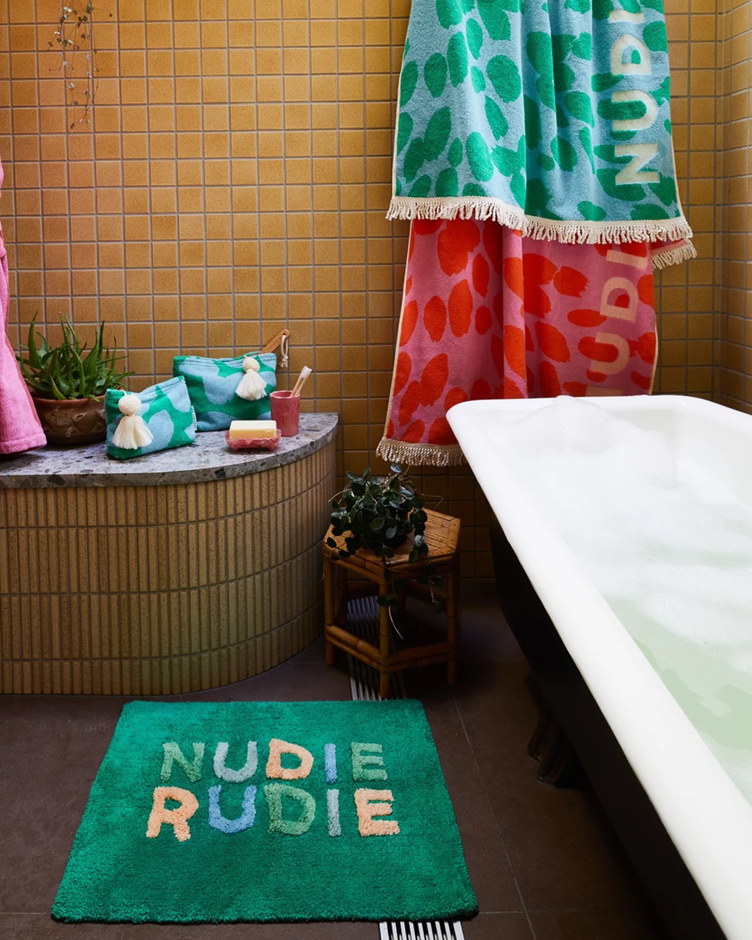 Green bath mat in bathroom next to bath