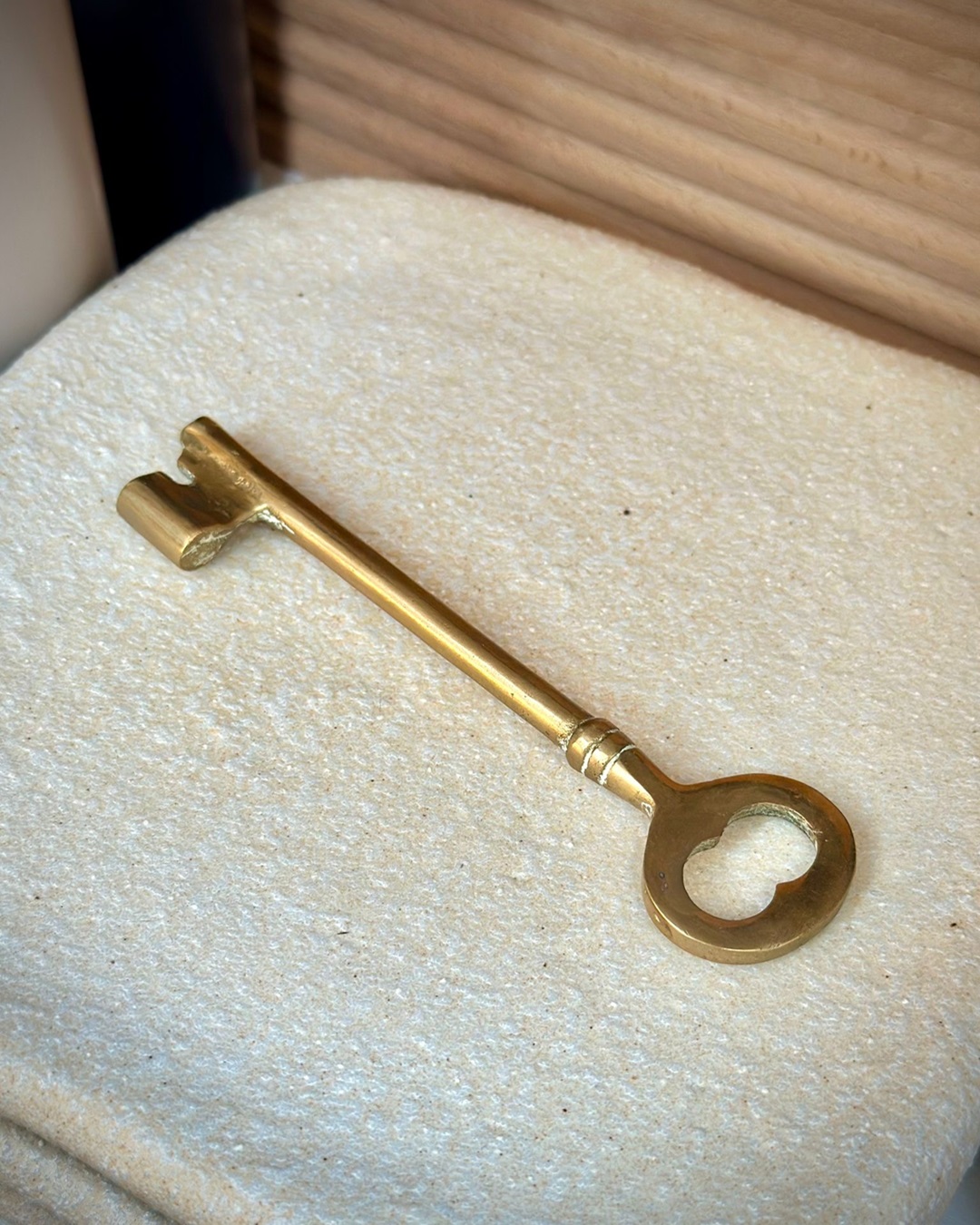 Brass key on white slab plate