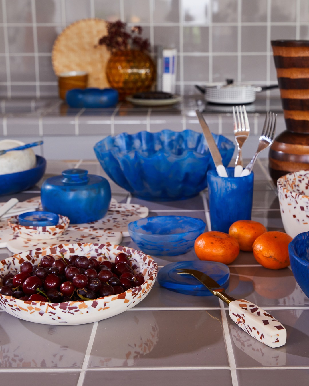 Red and orange terrazzo and brass cheese knife with bowls on table