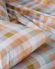 Checkered orange pillow and bedding