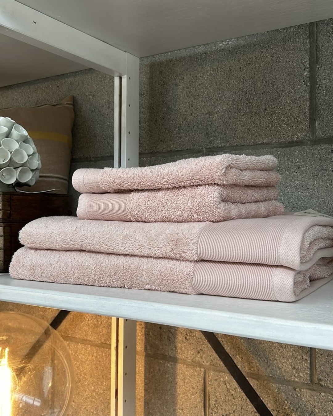 Pink bath towels and hand towels on shelf
