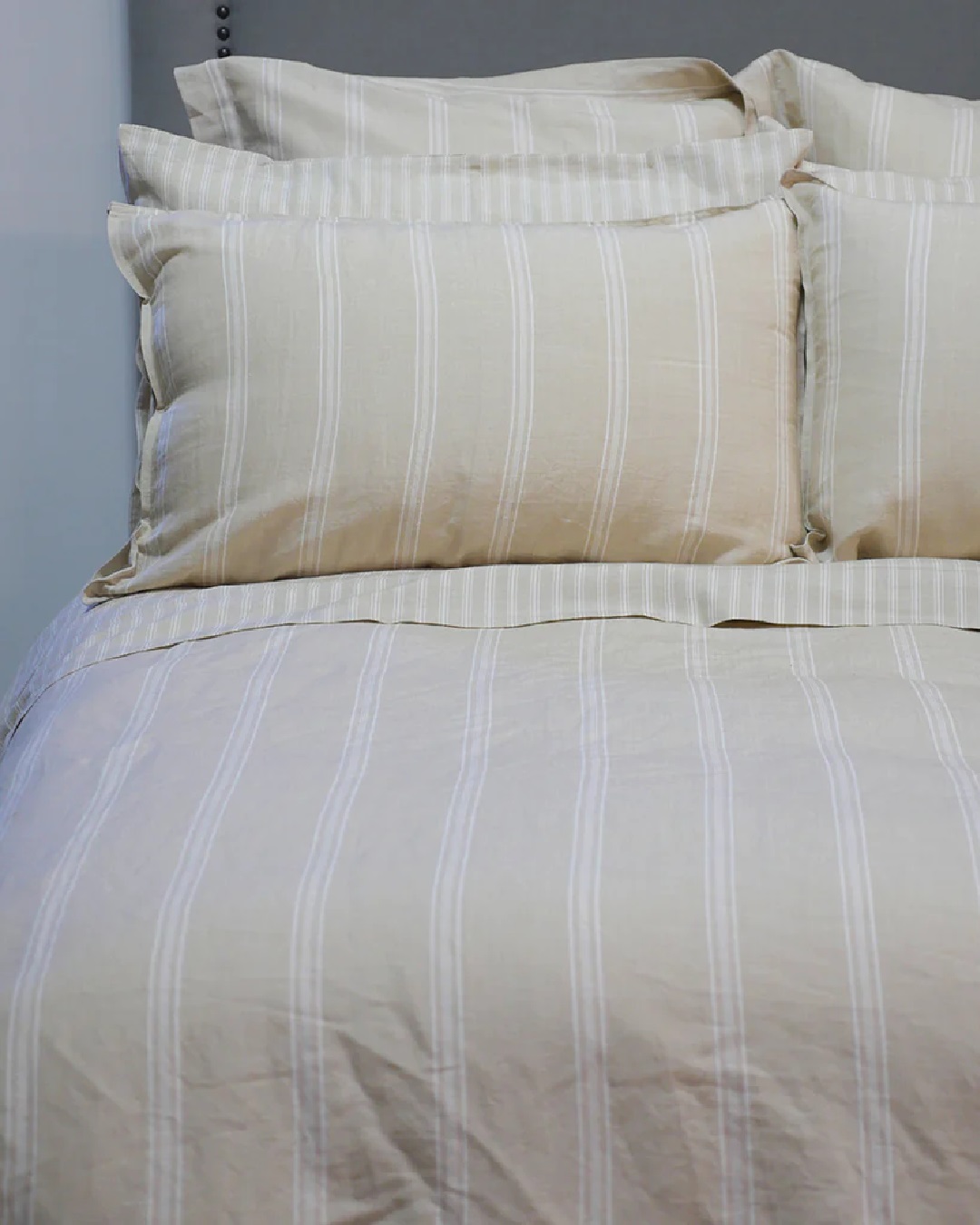 Off white striped duvet set on bed