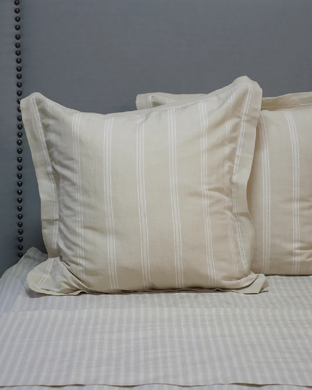 Off white striped Euro pillowcase on bed