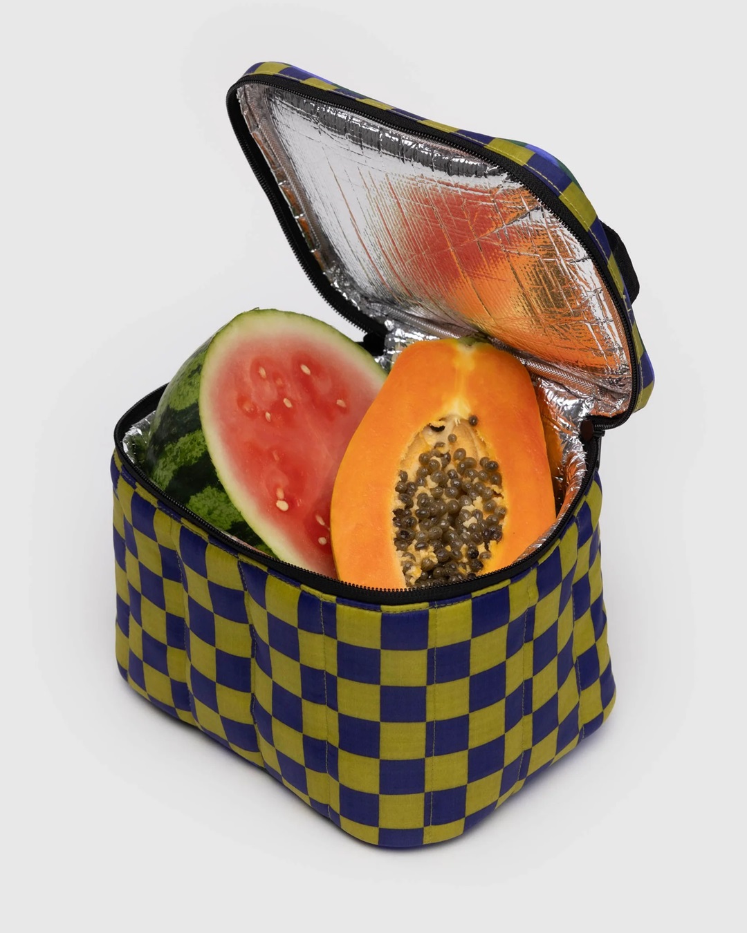 Check lunch bag green and blue with black zip and handle open with watermelon and papaya inside