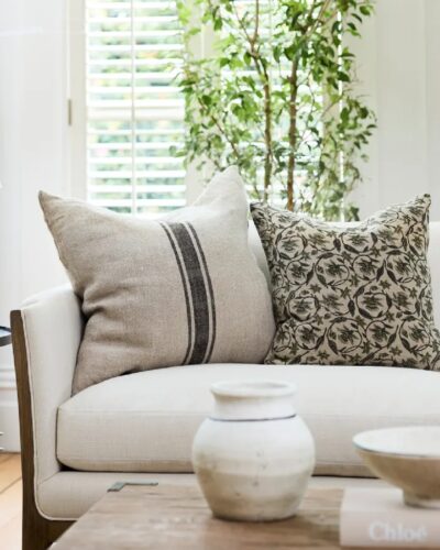 Russet stripe black and natural cushion on couch with cushions