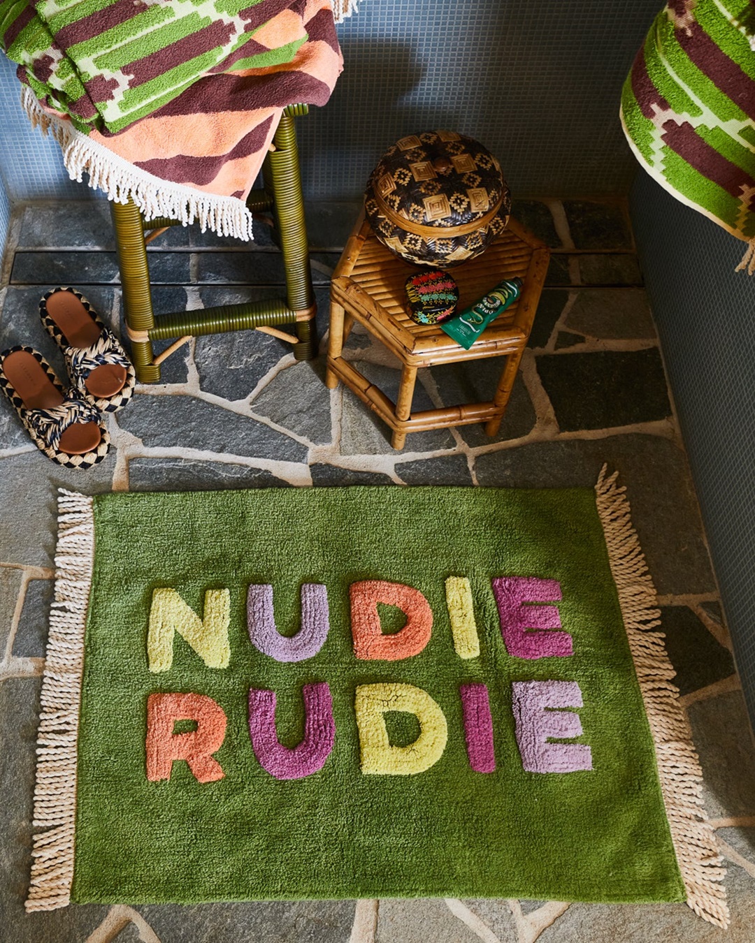 Green Nudie Rudie Bath Mat on bathroom floor