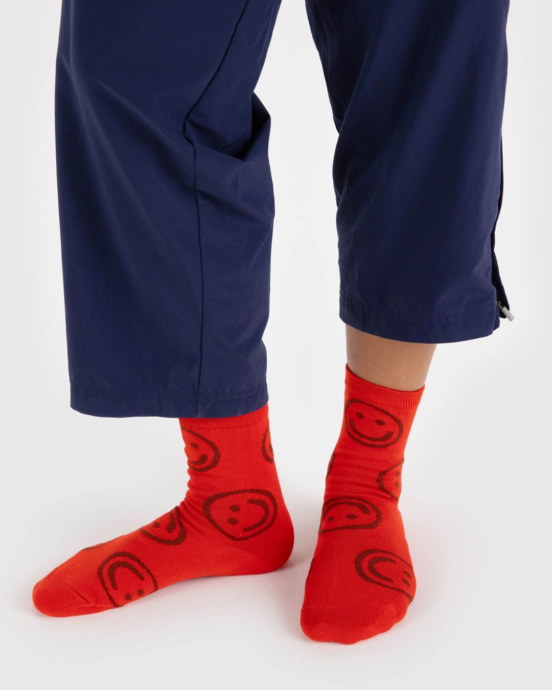 Red smiley face socks on feet