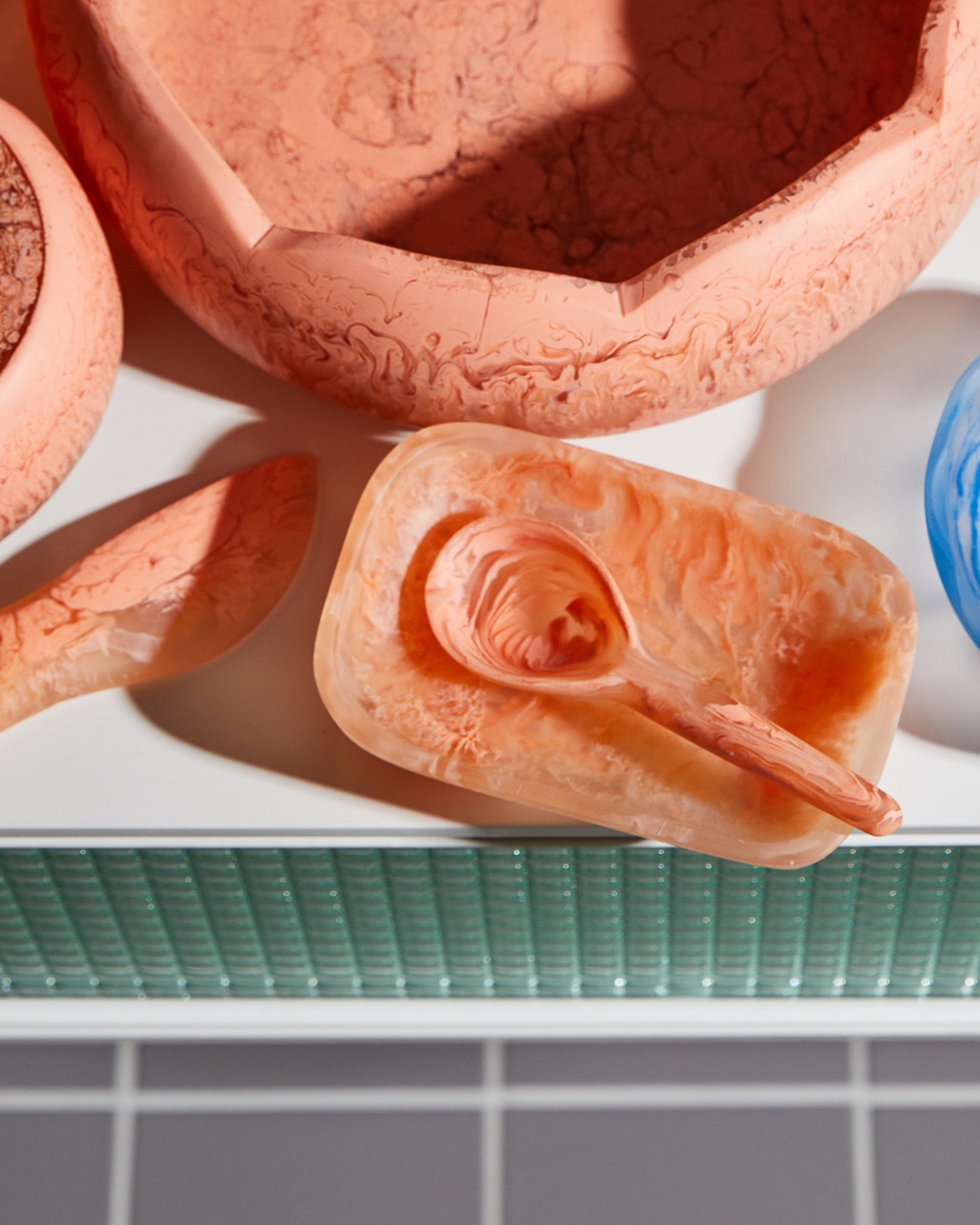 orange spoon on soap dish and bowls on table