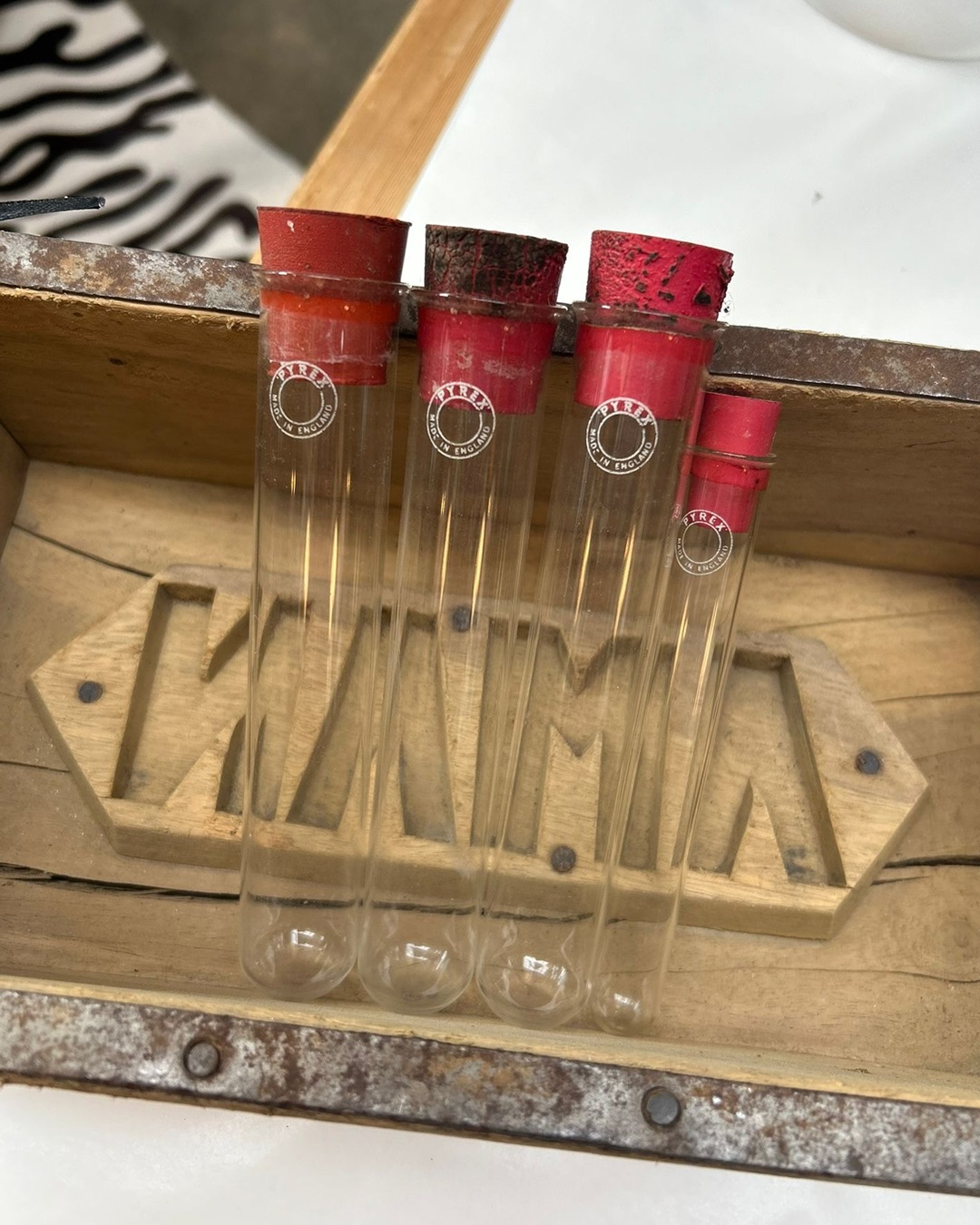 Test tubes with red rubber lids in wooden mould