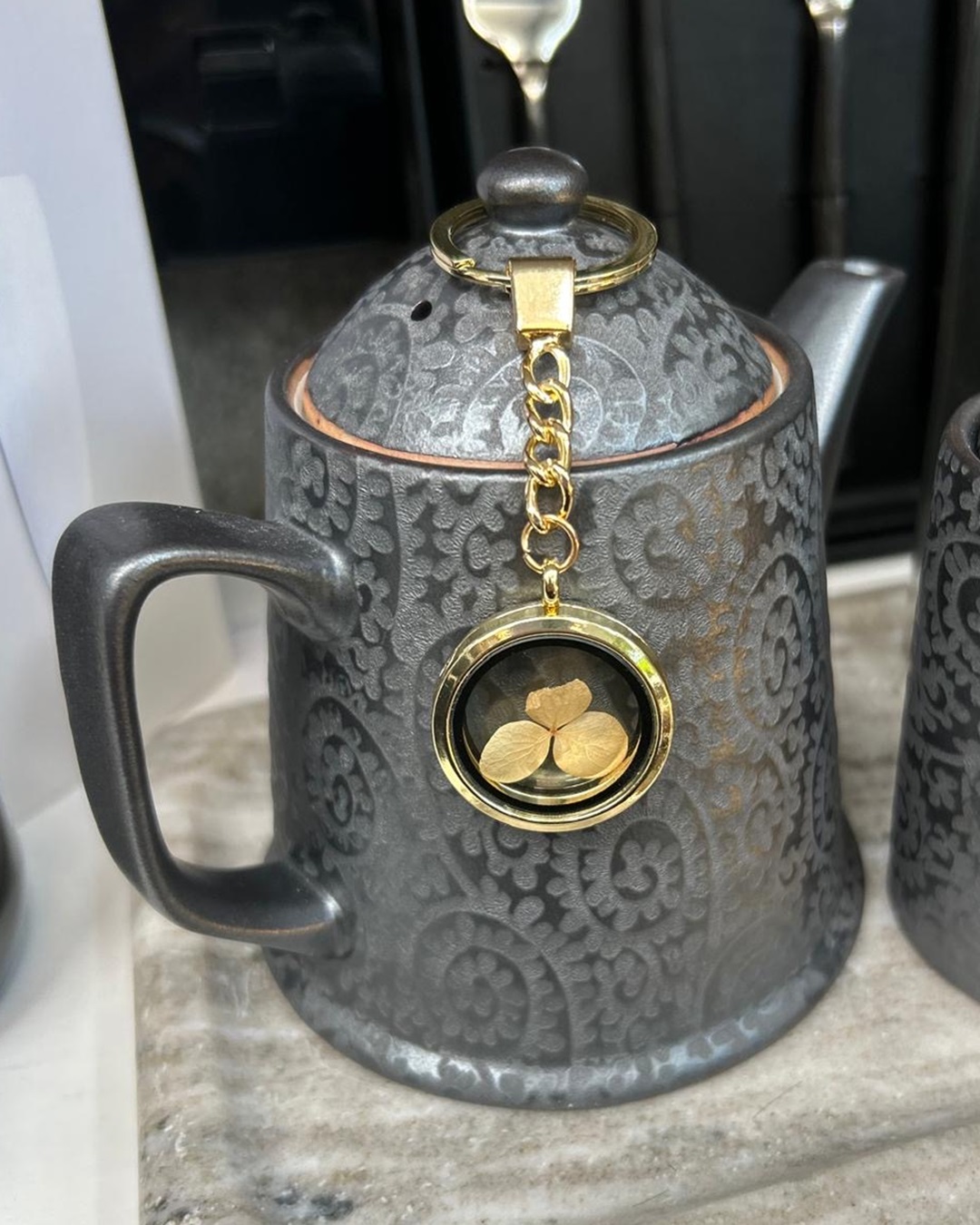 Treasure gold key ring on tea pot