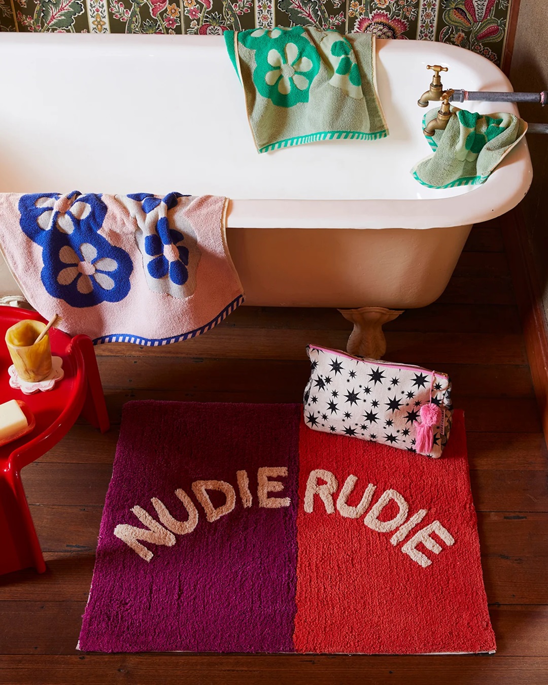 Red and orange Nudie Rudie Bath Mat on bathroom floor