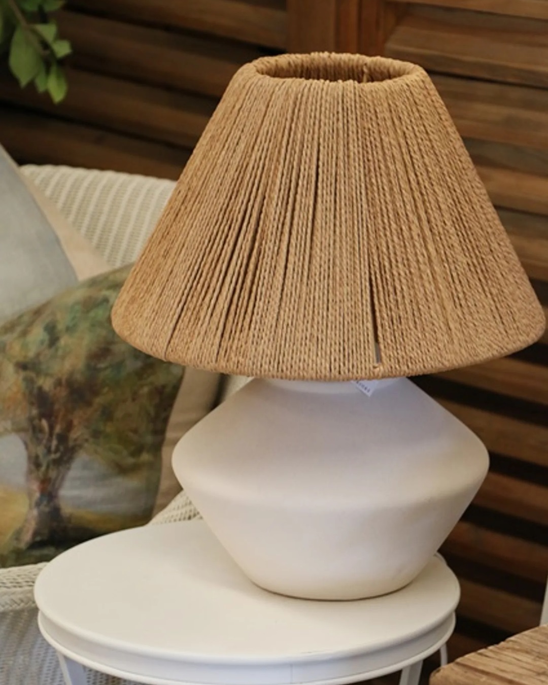 White lamp with loom shade on table