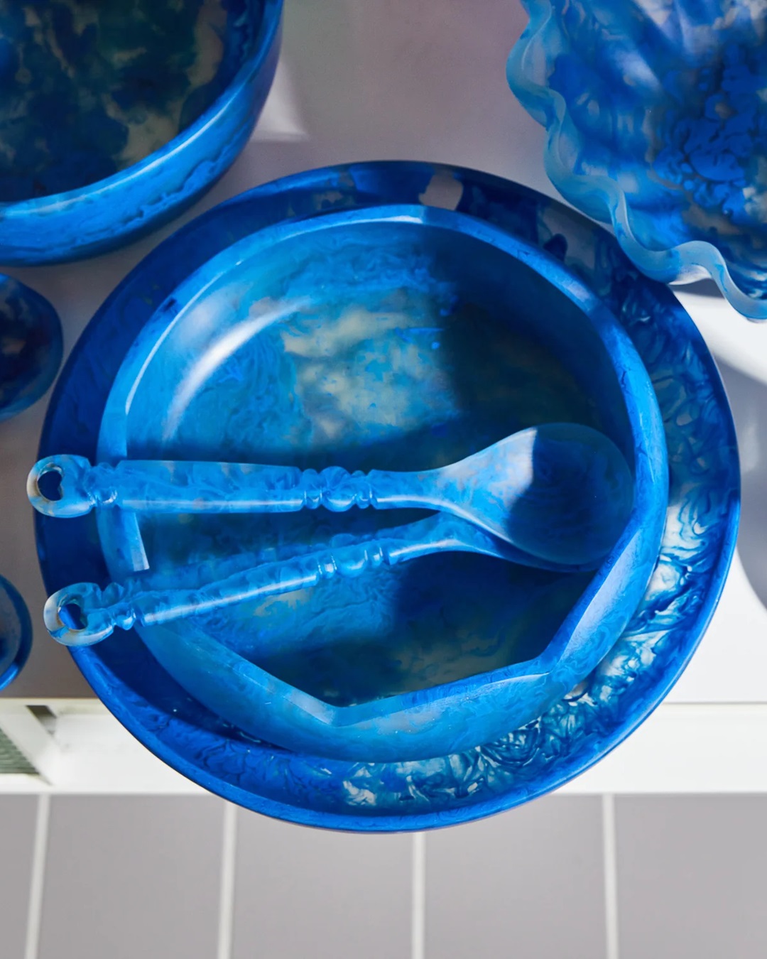 Blue resin salad servers in bowls