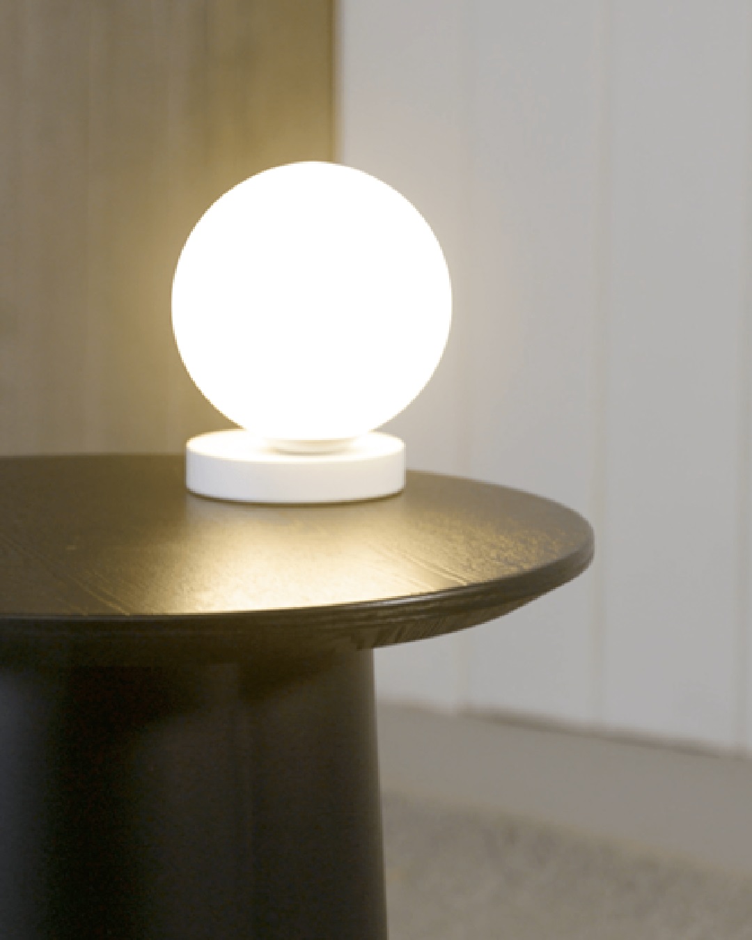 Round white lamp on table