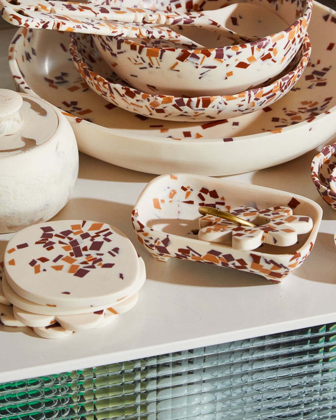 Red and orange terrazzo soap dish with coasters and bowls