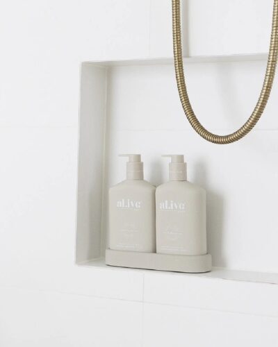 Al.ive wash and lotion duo in tray on shelf in bathroom